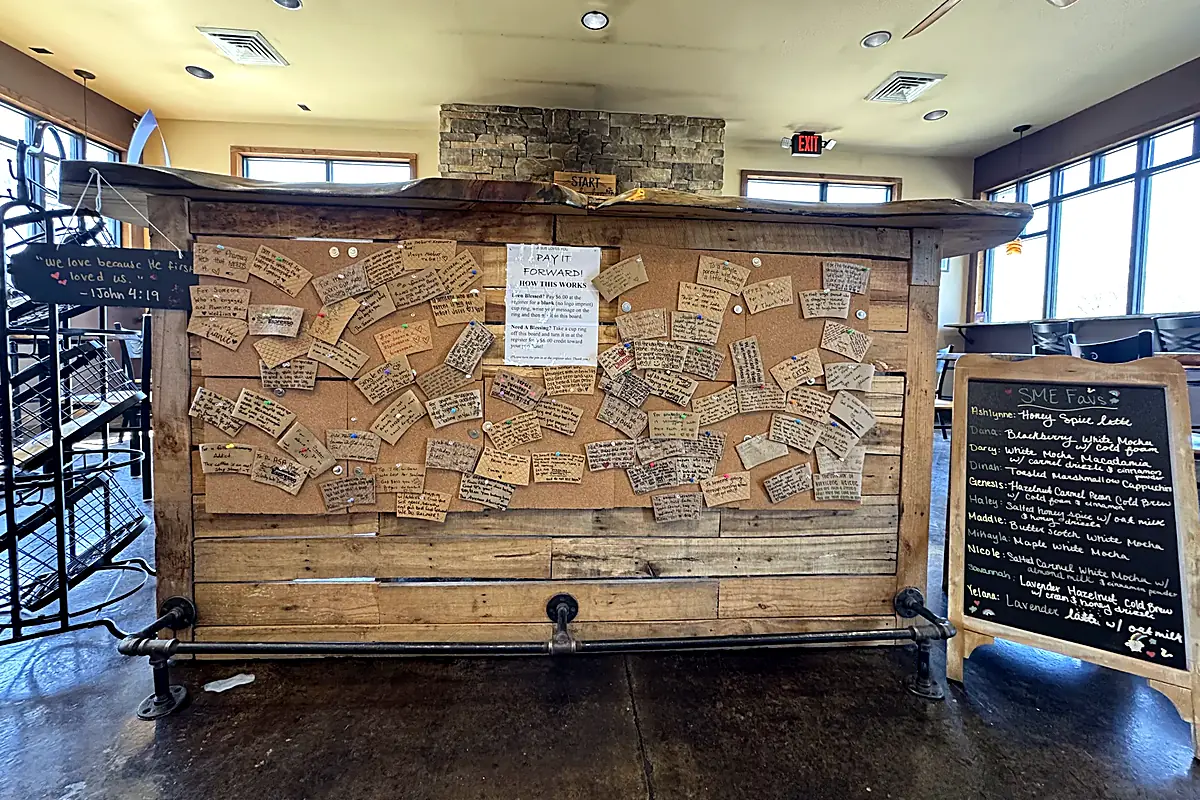 The pay-it-forward board inside Smoky Mountain Espresso, covered in handwritten notes of encouragement